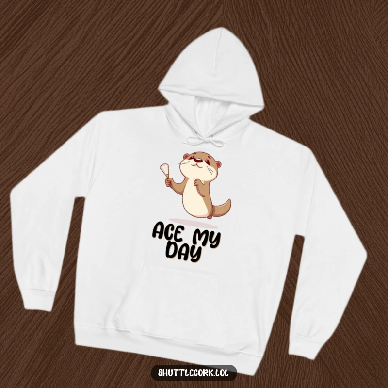 Funny otter hoodie showcasing a curious otter making an athletic leap for a shuttlecock, perfect for badminton lovers.